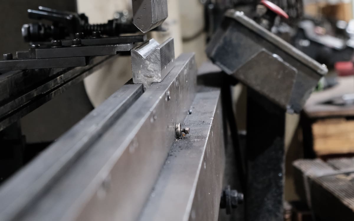Custom press brake tooling mounted in the brake