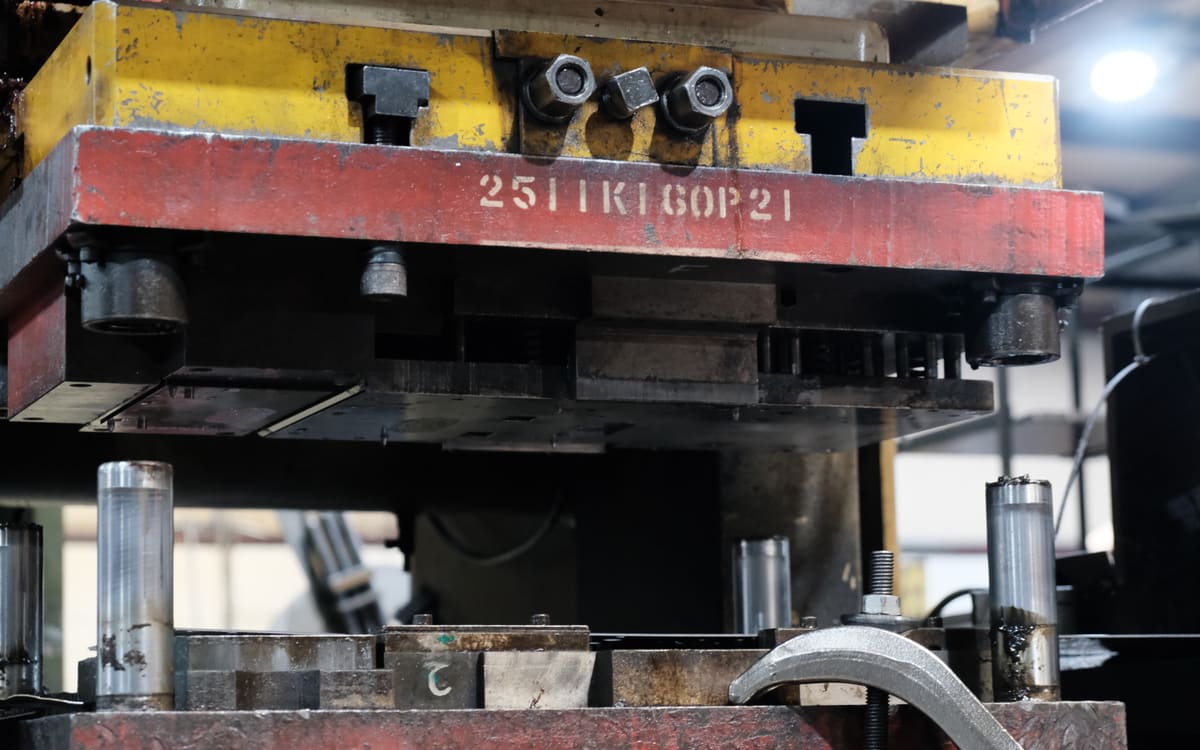 A complete die set mounted in a stamping press