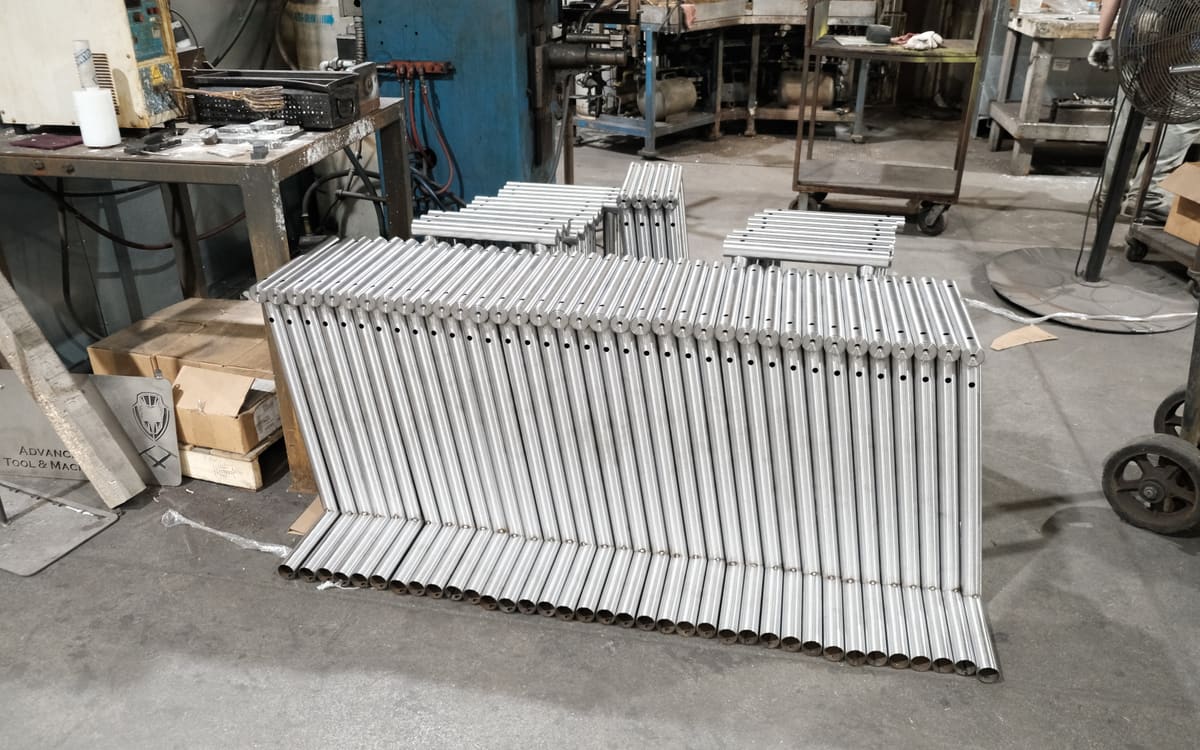 Welded tube frames staged on the shop floor